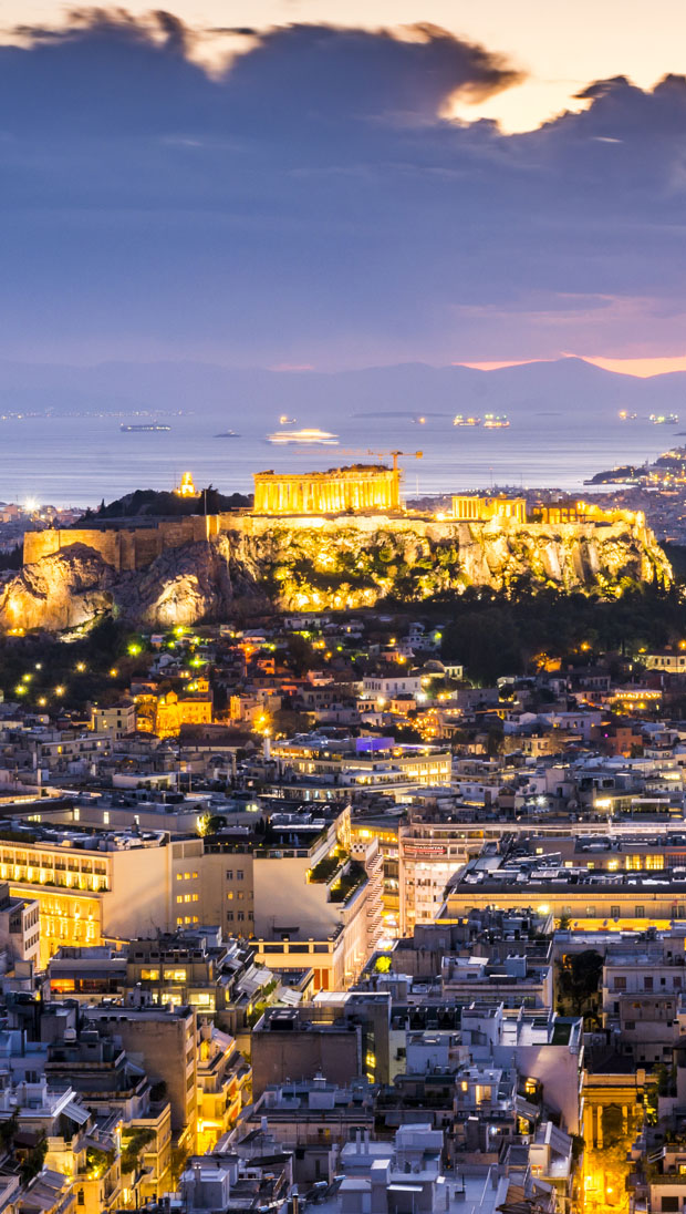 Acropolis lit up as the evening darkness begins in Athens Greece