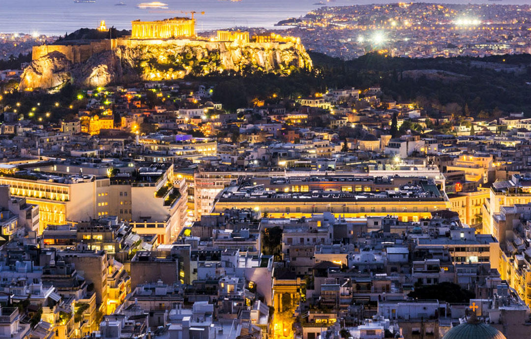 Acropolis Lit up as evening starts in Athens Greece
