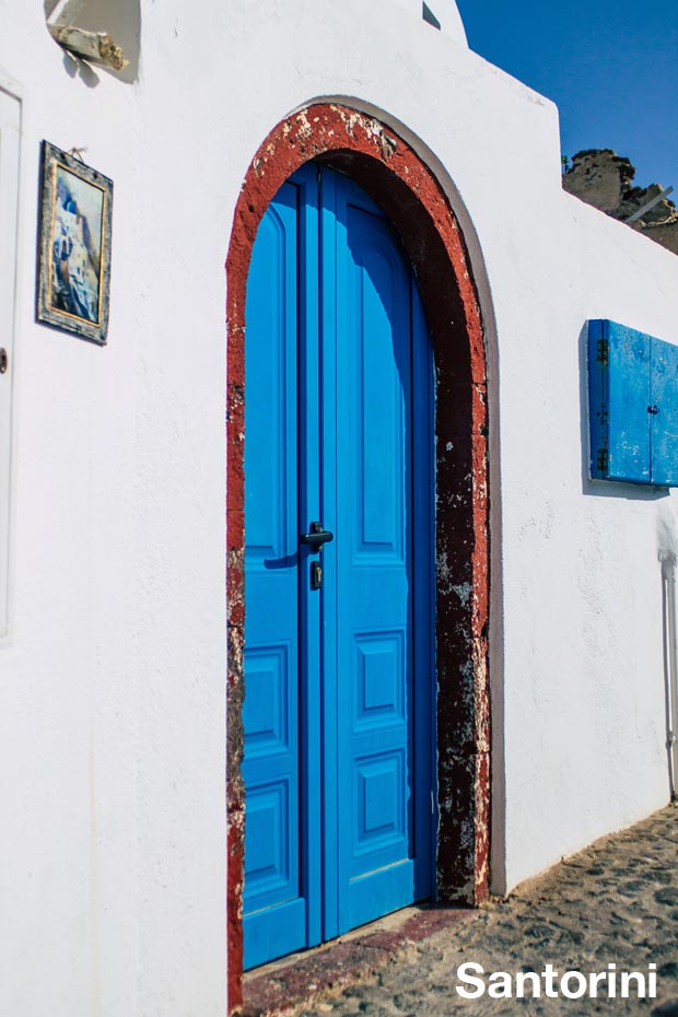 Doorway on Santorini with blue painted door and red trim