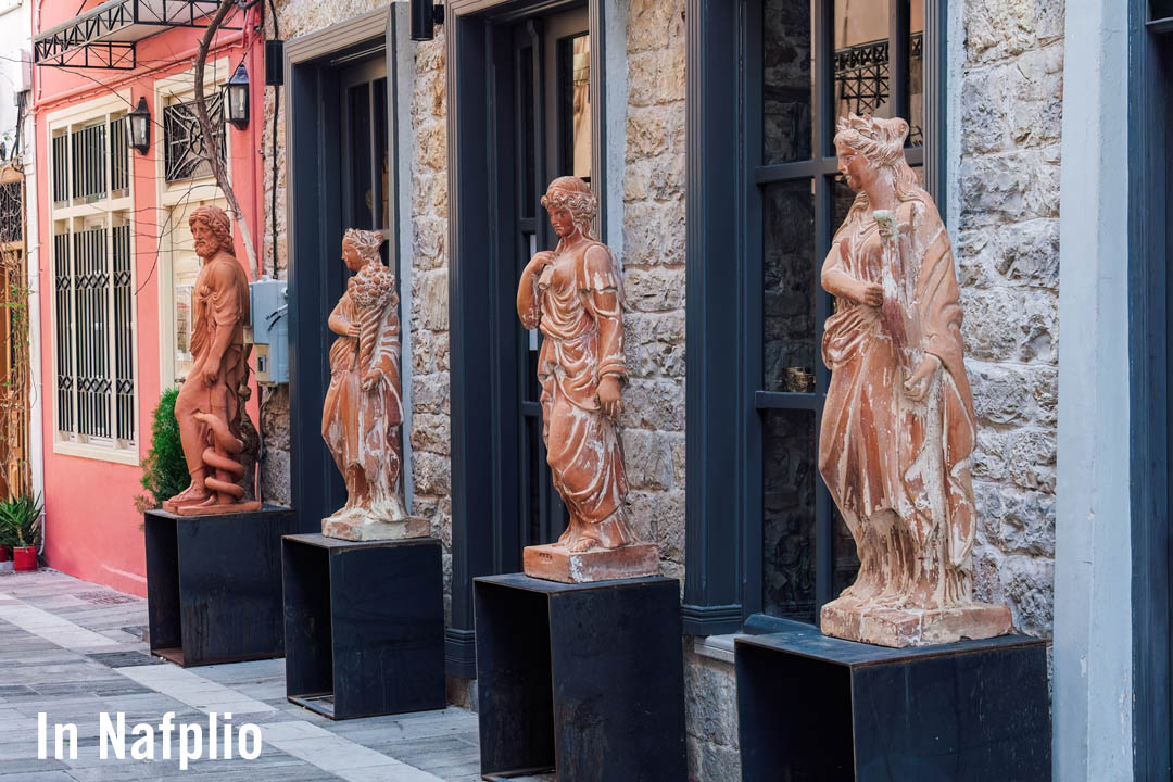 Nafplio display of Ancient Greek statue reproductions on the sidewalk