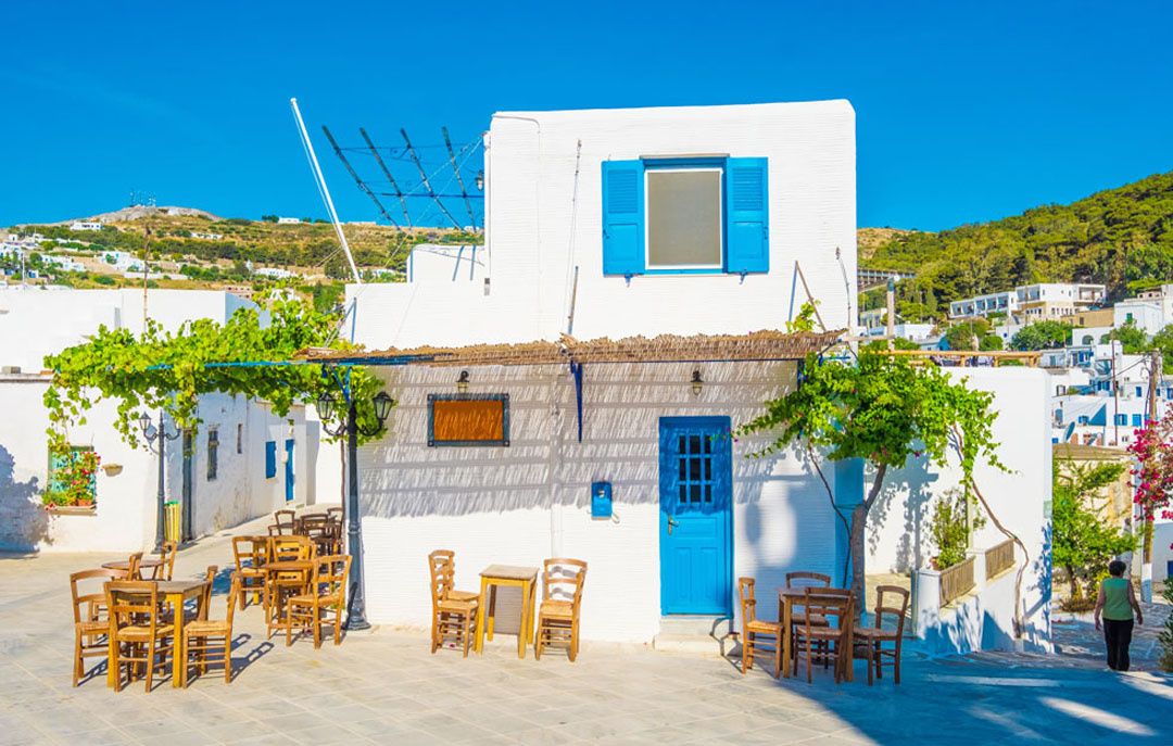 Traditional Greek Home with white-washed walls and blue shutters and door