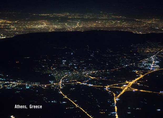 Athens at night with the outline of Ymittos Mountain