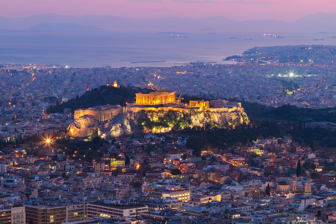 Dusk colors over the Acropolis and Parthenon with Piraeus in the distance
